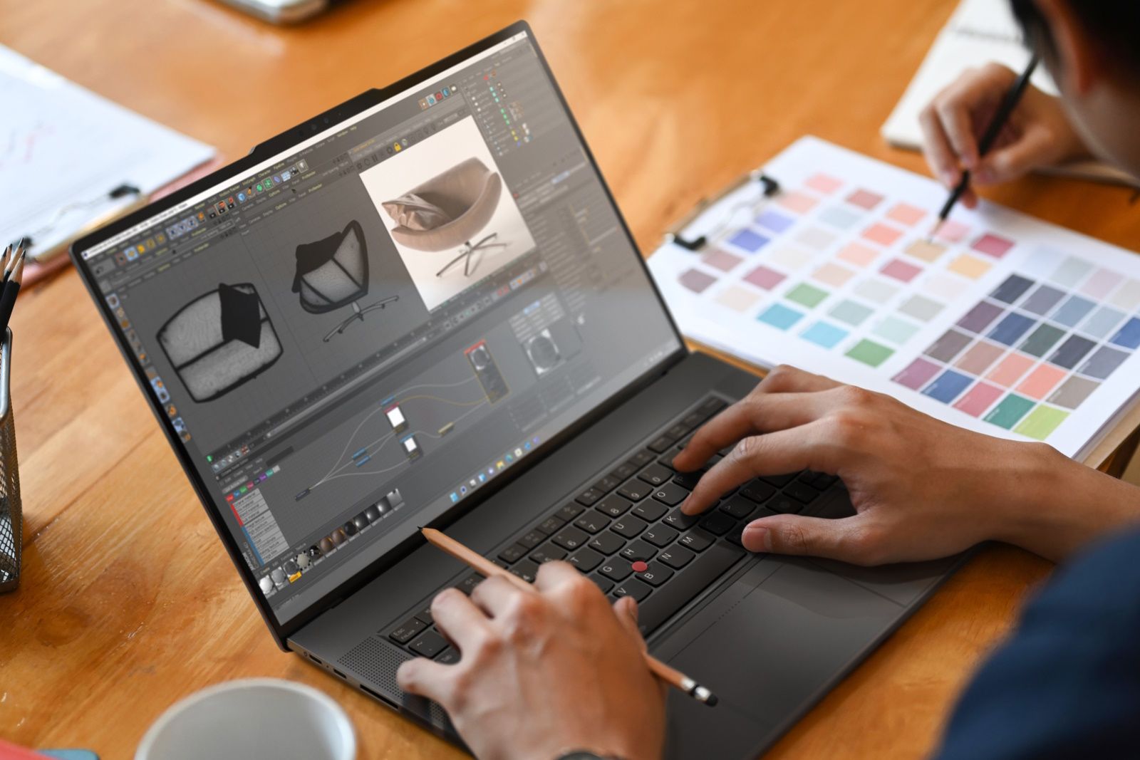 hands typing on laptop working on furniture design