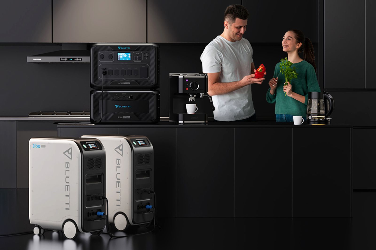 A man and woman use power stations in a black kitchen