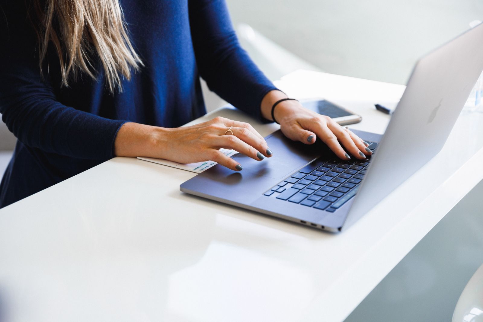 Woman in Business Setting Using Laptop