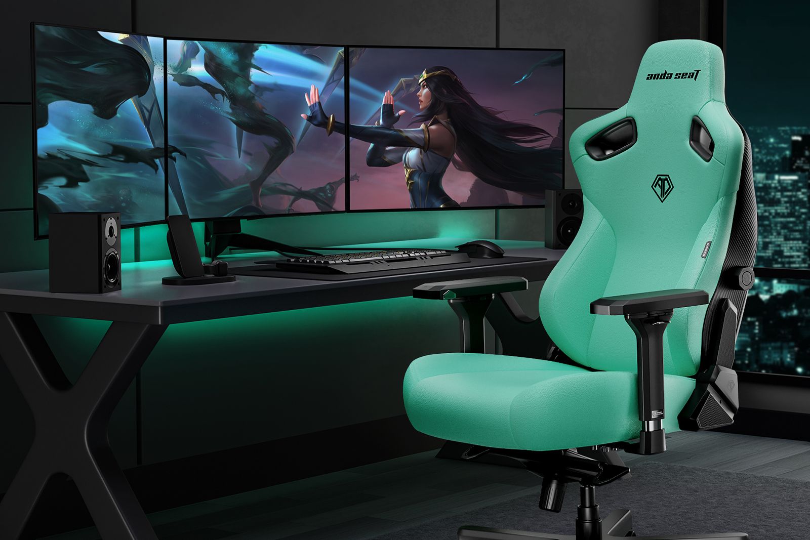 A green gaming chair sits beside a desk with triple screens