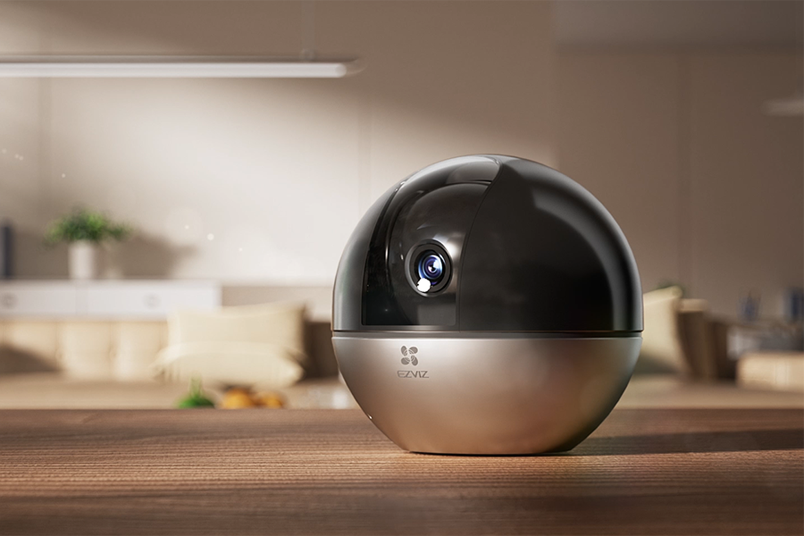 A black and silver indoor camera on a wooden table