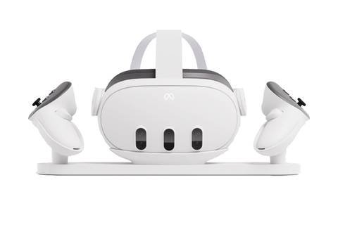 A white charging dock with two controllers and a Quest 3 headset sitting in it.