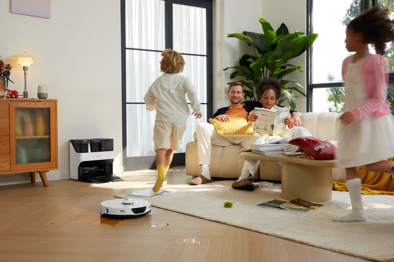 roborock vacuum on floor with family