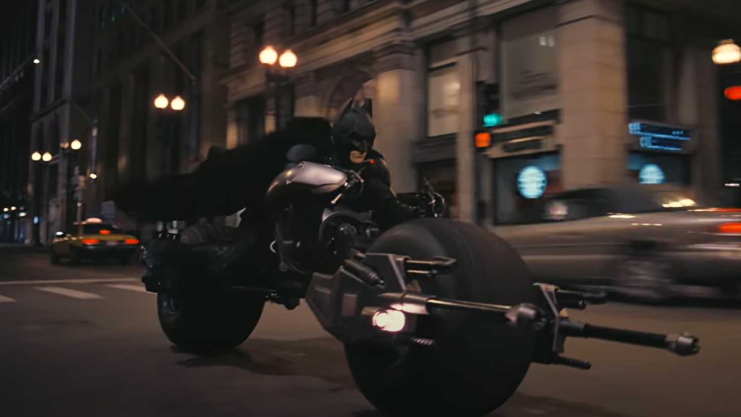 Batman riding a motorcycle in The Dark Knight.