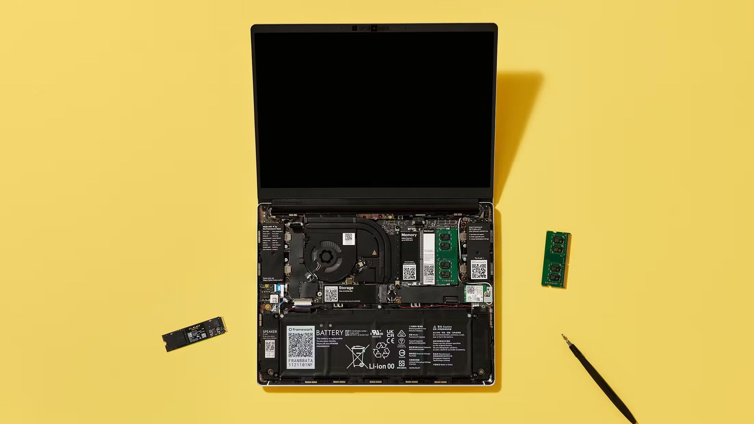 Framework laptop on a yellow surface. 