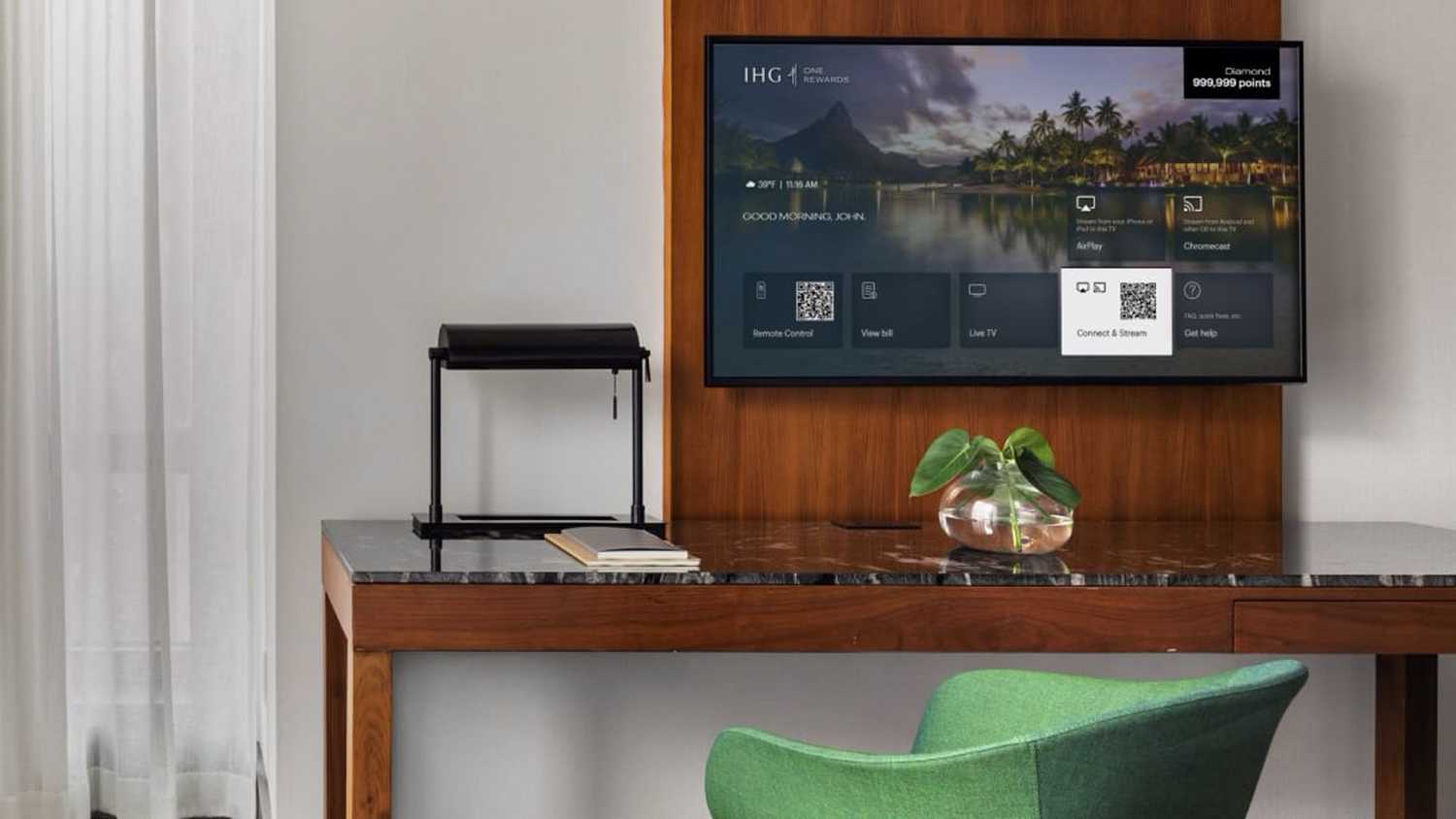 An LG TV displays IHG's check-in interface.
