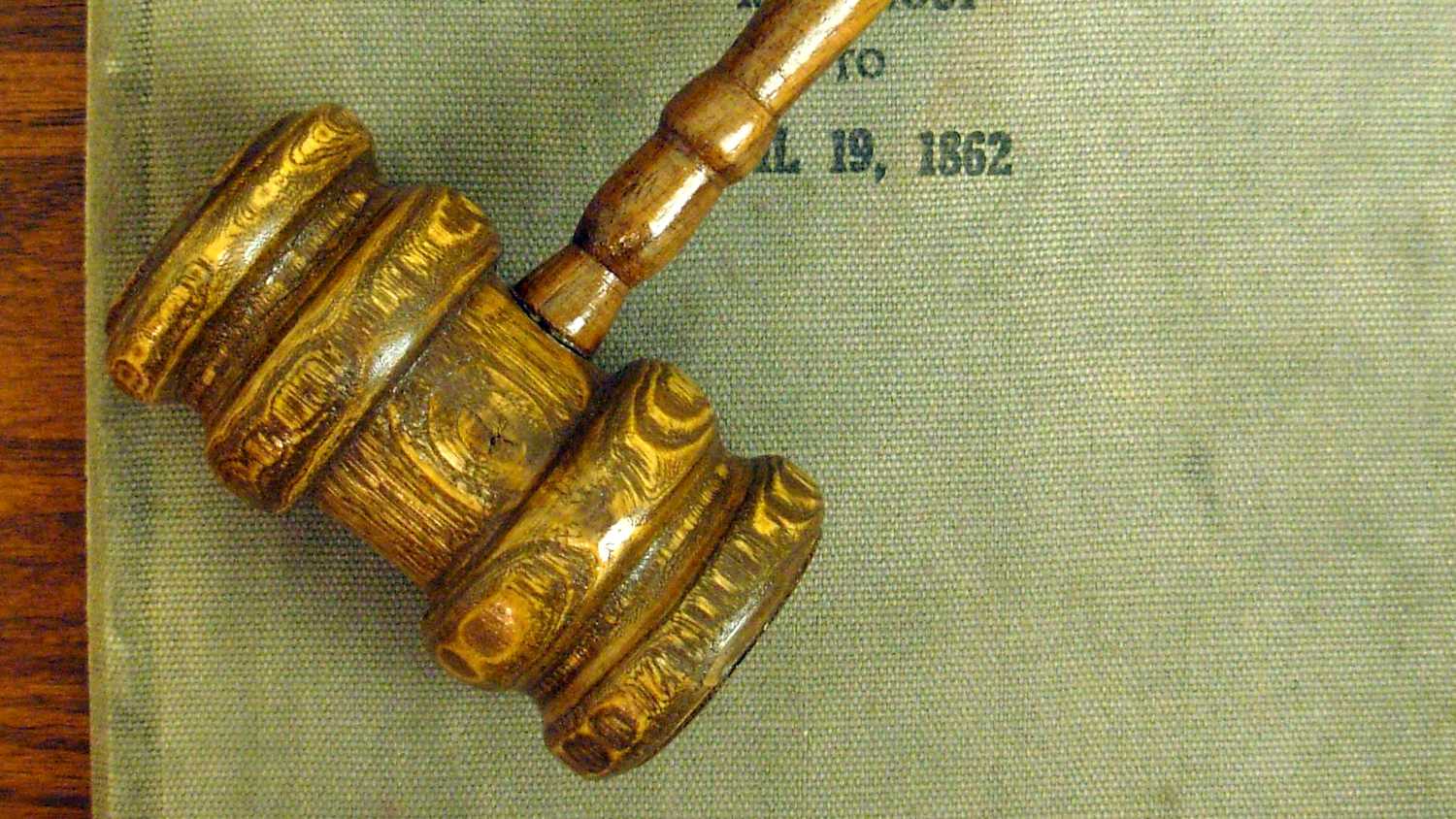 A gavel on top of court minutes.