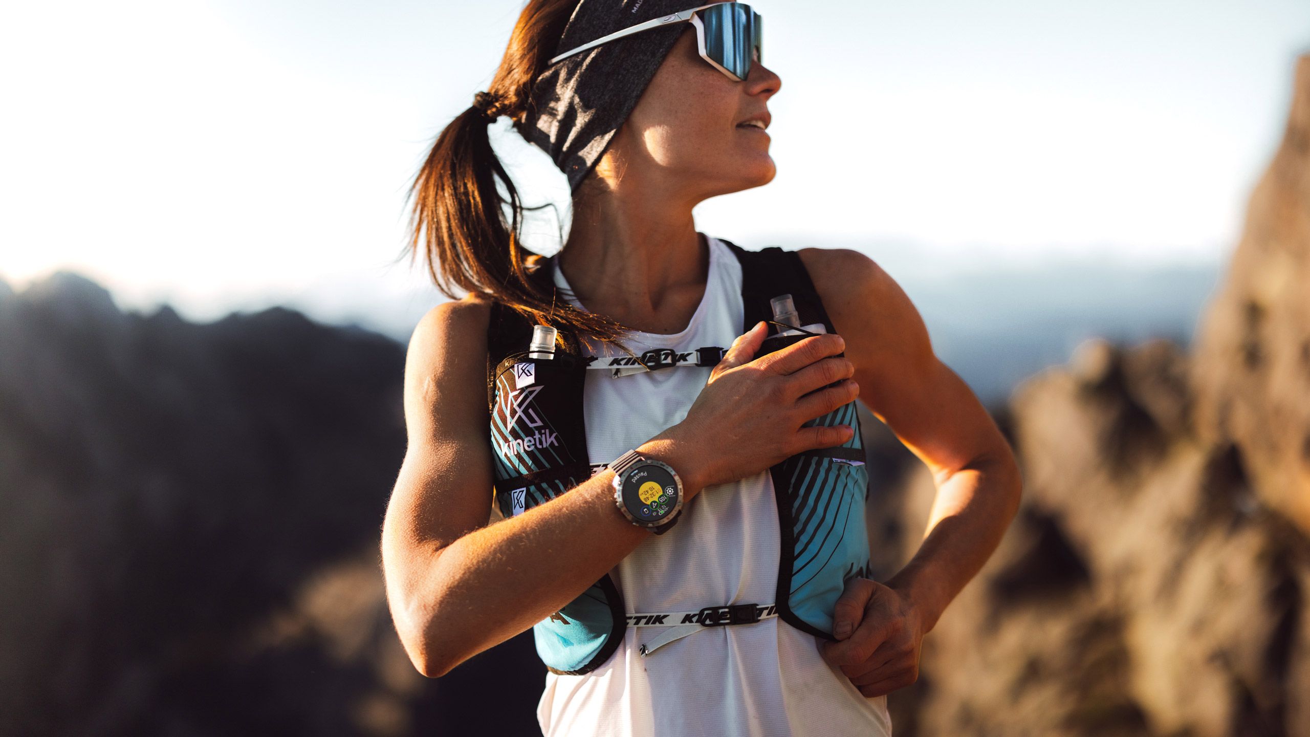 A female trail runner wears the Polar Grit X2 Pro on her wrist
