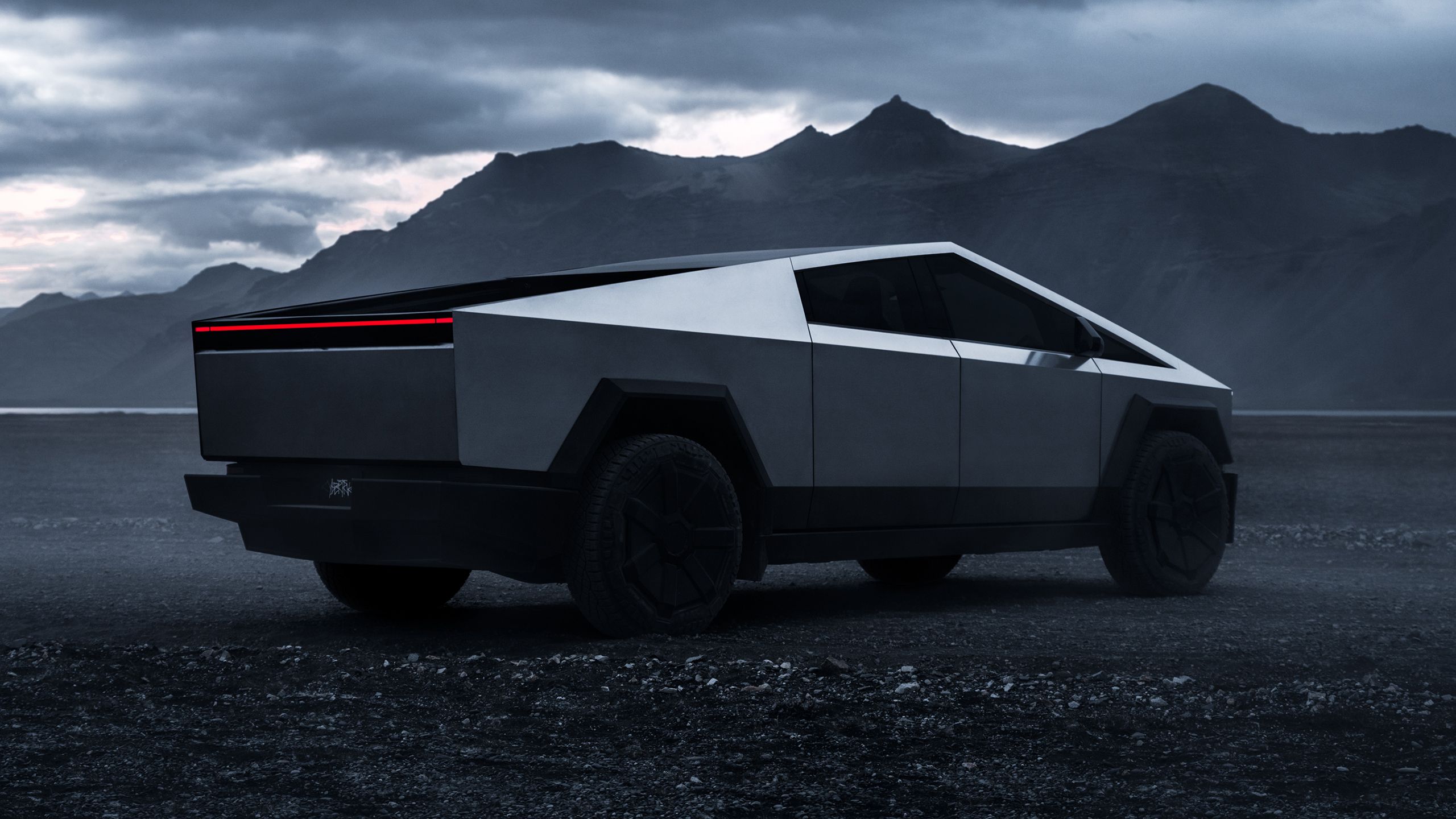 Tesla Cybertruck in a dark landscape.