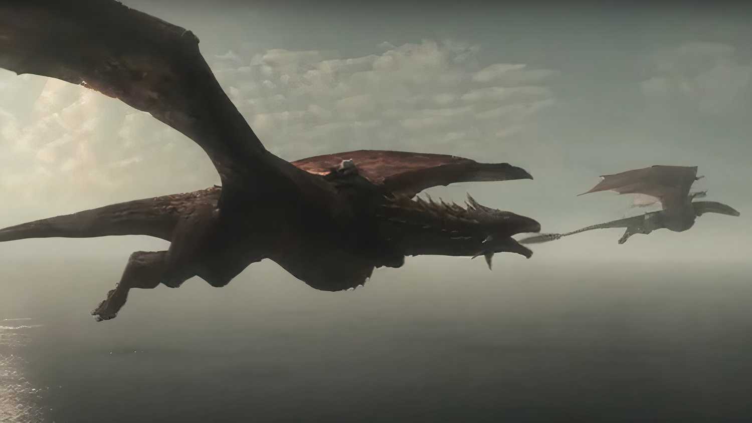 House of the Dragon dragons flying over a hazy sea.