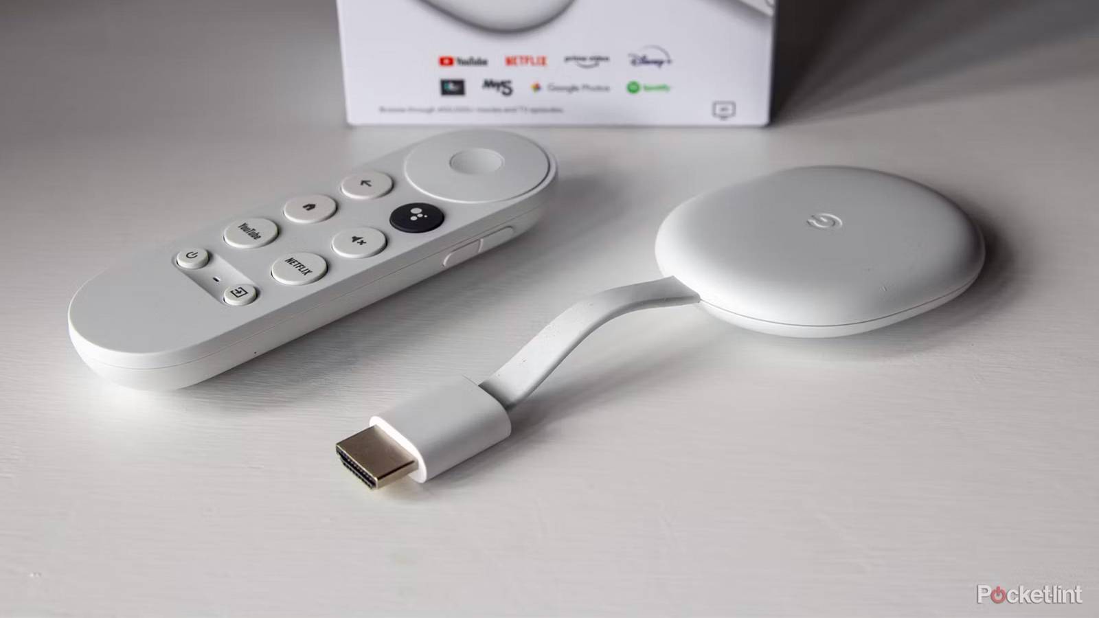 A Chromecast with Google TV sits on a white table.
