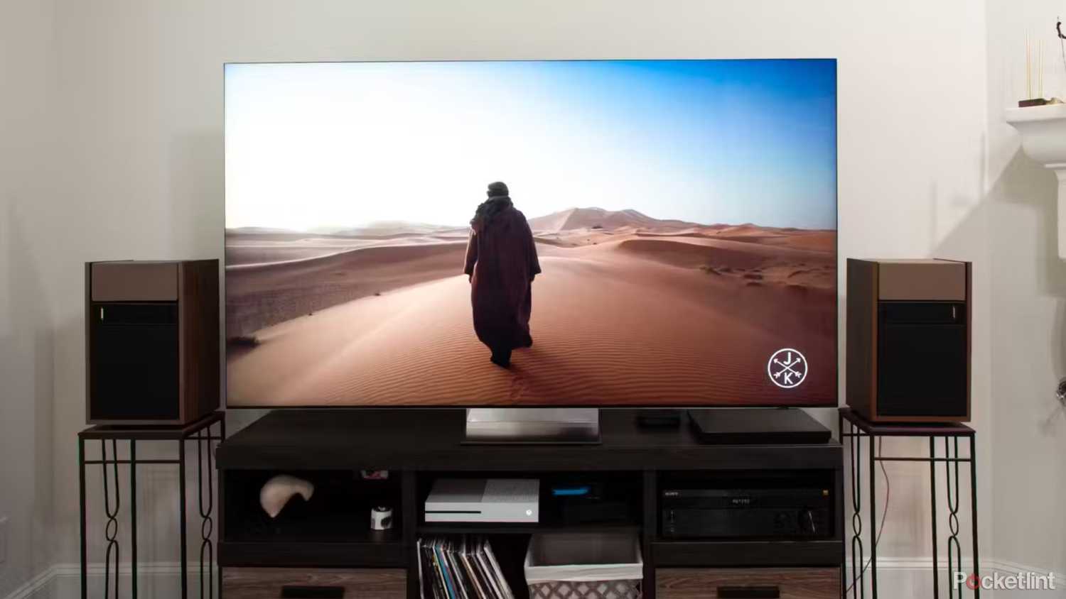 A Samsung QN900D 8K TV showing a person walking across a desert.