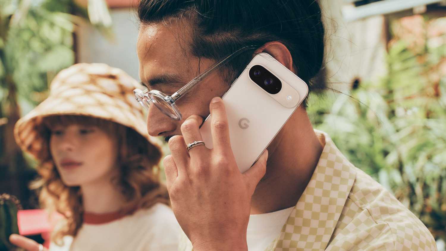 A man taking a phone call on a Pixel 9.