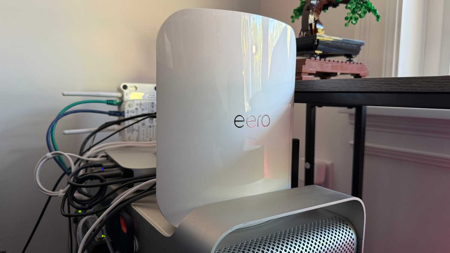The Eero Max 7 Wi-Fi router sitting on a desktop computer.