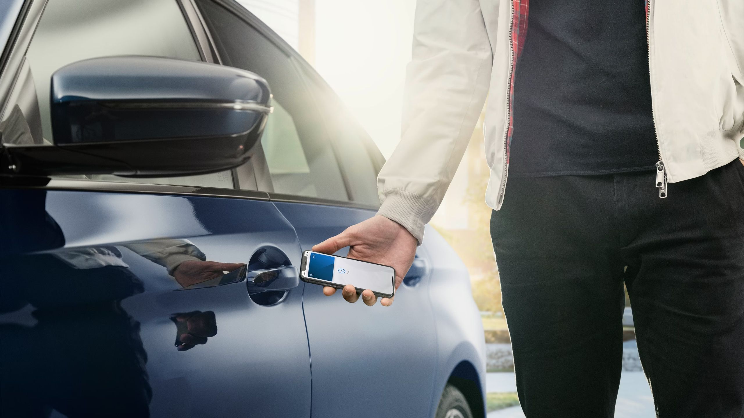 Unlocking a car using an Apple car key on an iPhone.
