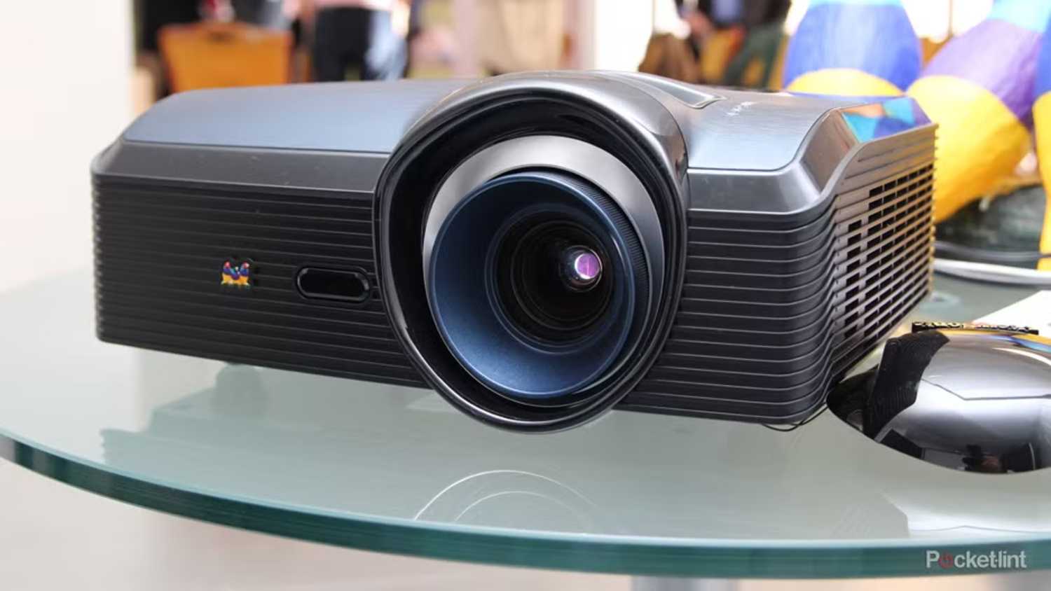 A projector on a glass table. 