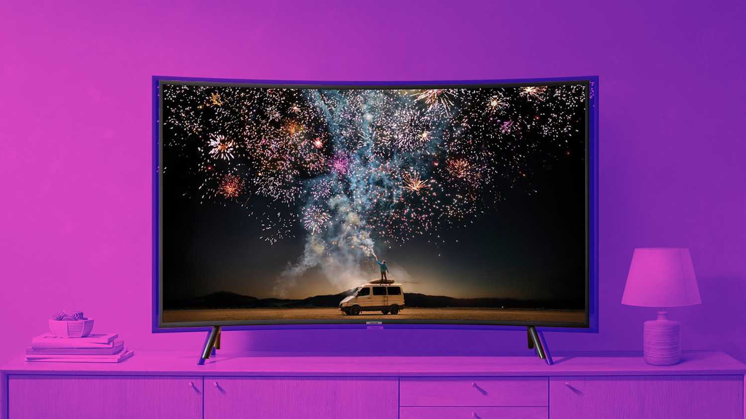 A curved TV displaying fireworks. 