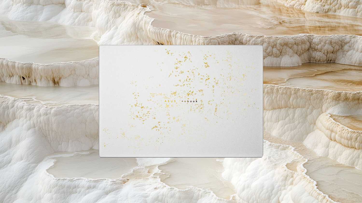 A white and gold Zenbook over a rock formation. 