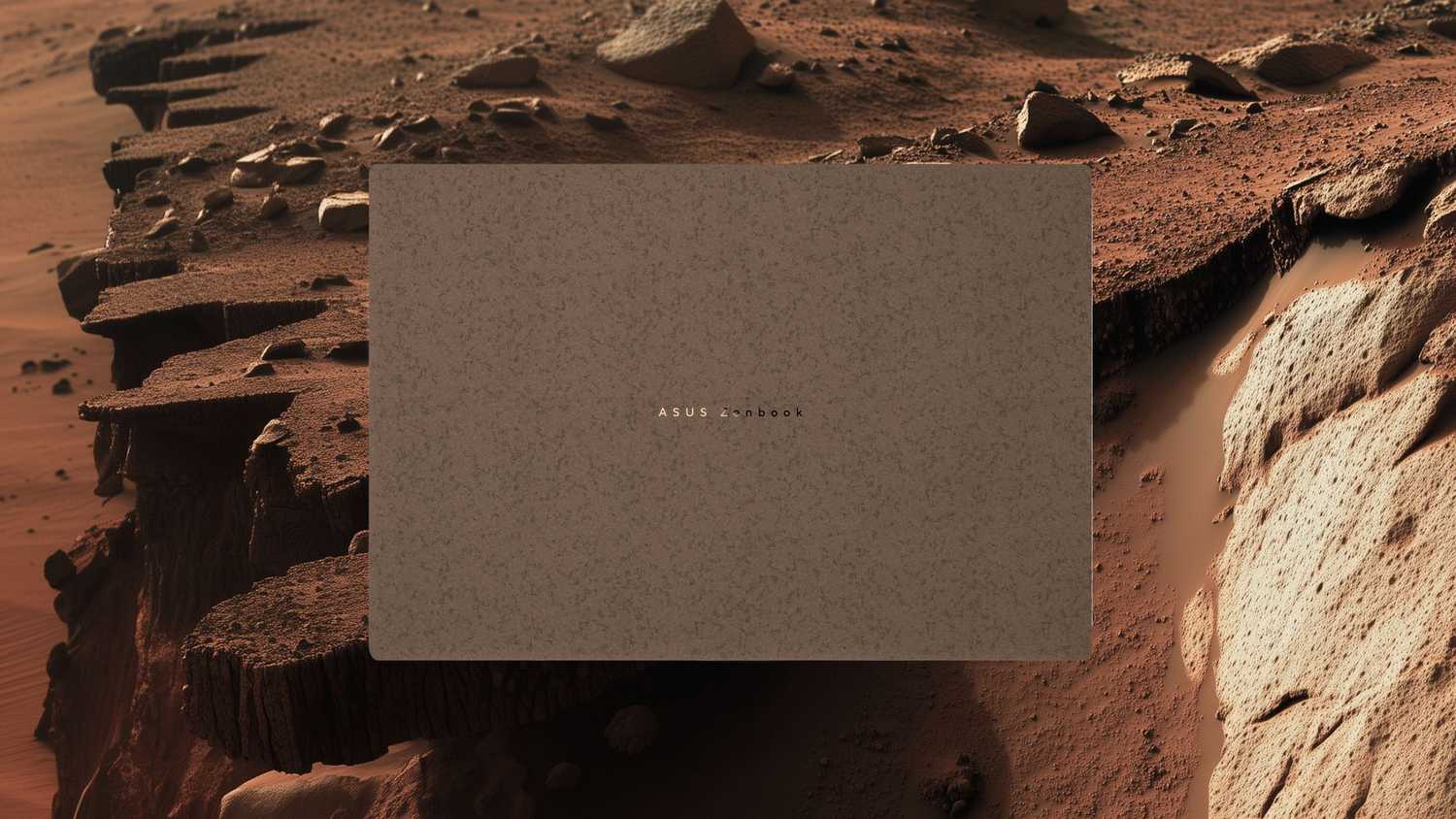 Terra Mocha Zenbook in front of a rocky place. 