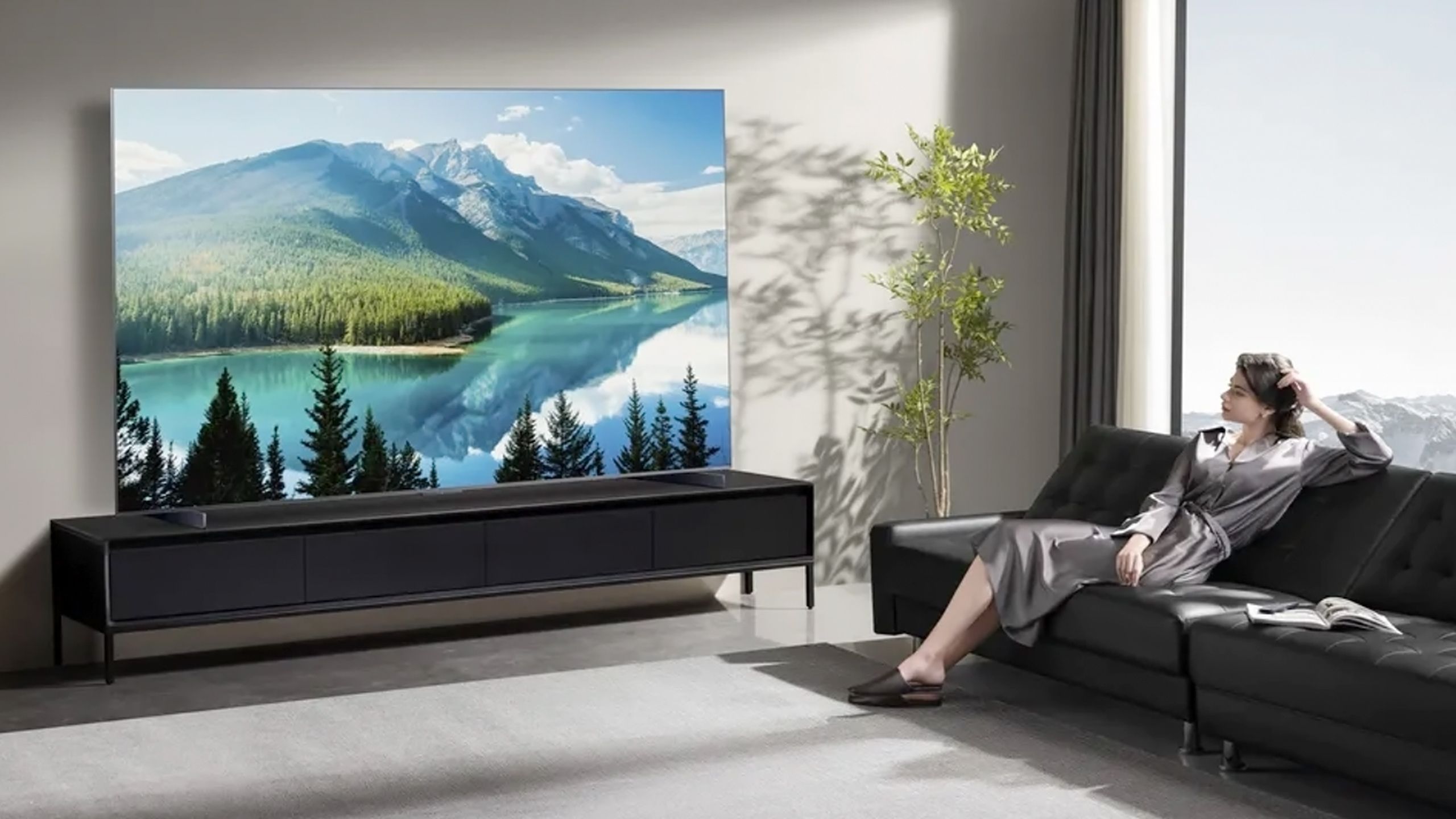 A model watches TCL's QM8K mini-LED TV