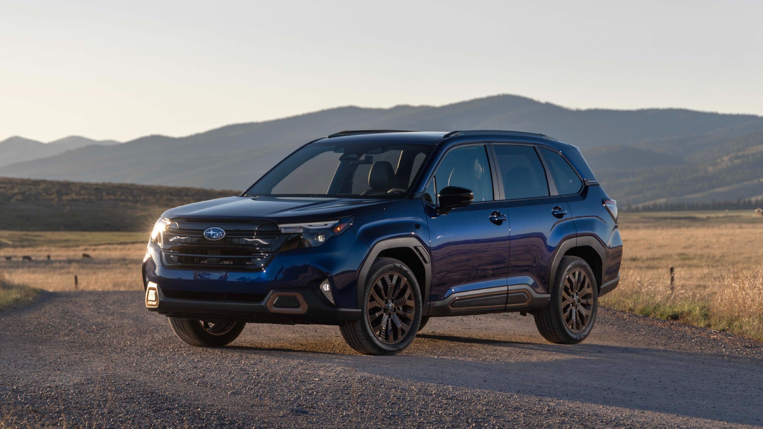 Front quarter view of the 2025 Subaru Forester hybrid parked at dawn.