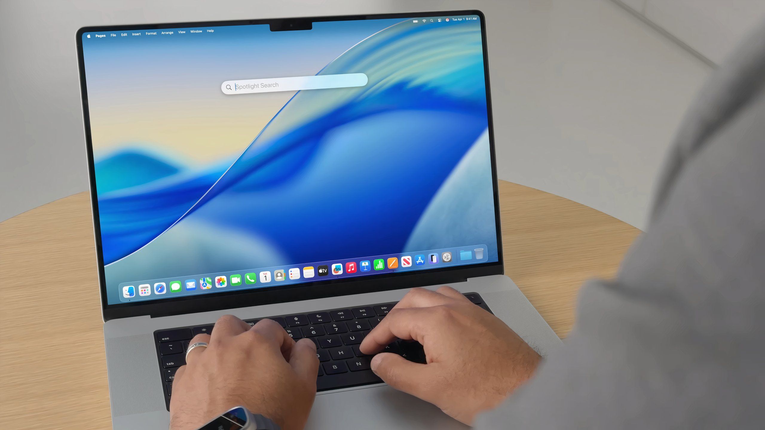Pulling up Spotlight in macOS 26 on a MacBook Pro.