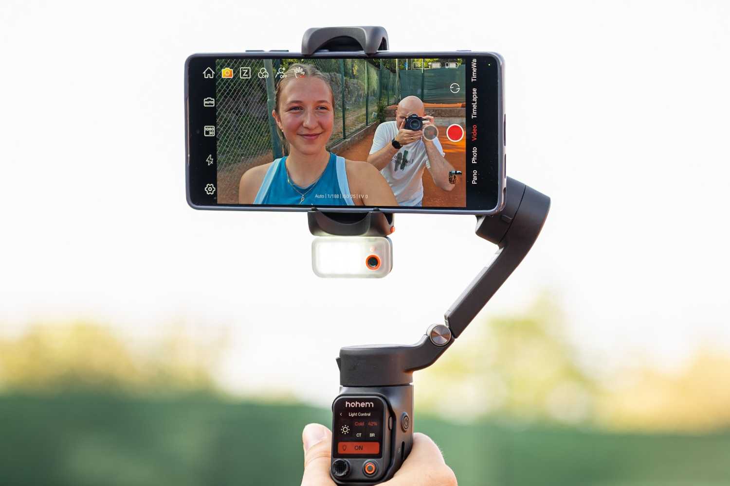 A person holding a smartphone gimbal.