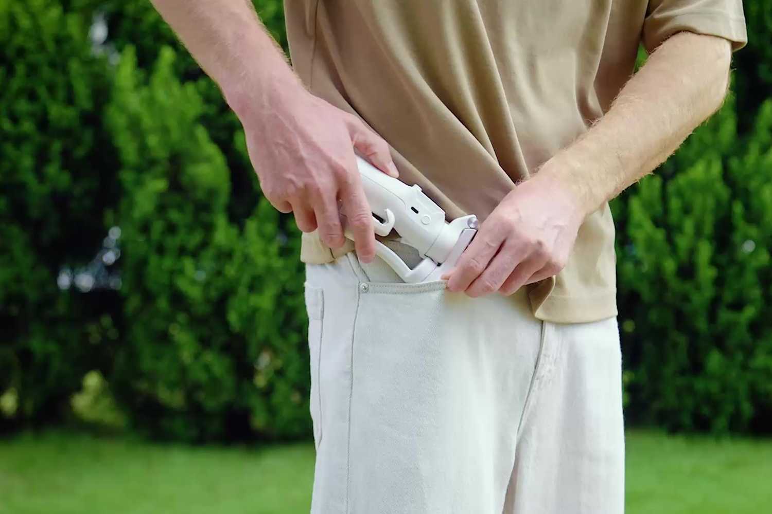 Man putting a gimbal into a pocket