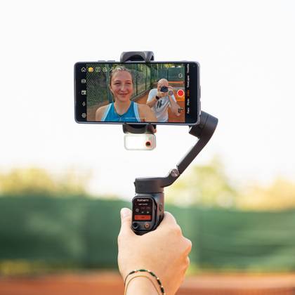 Person holding a smartphone gimbal.