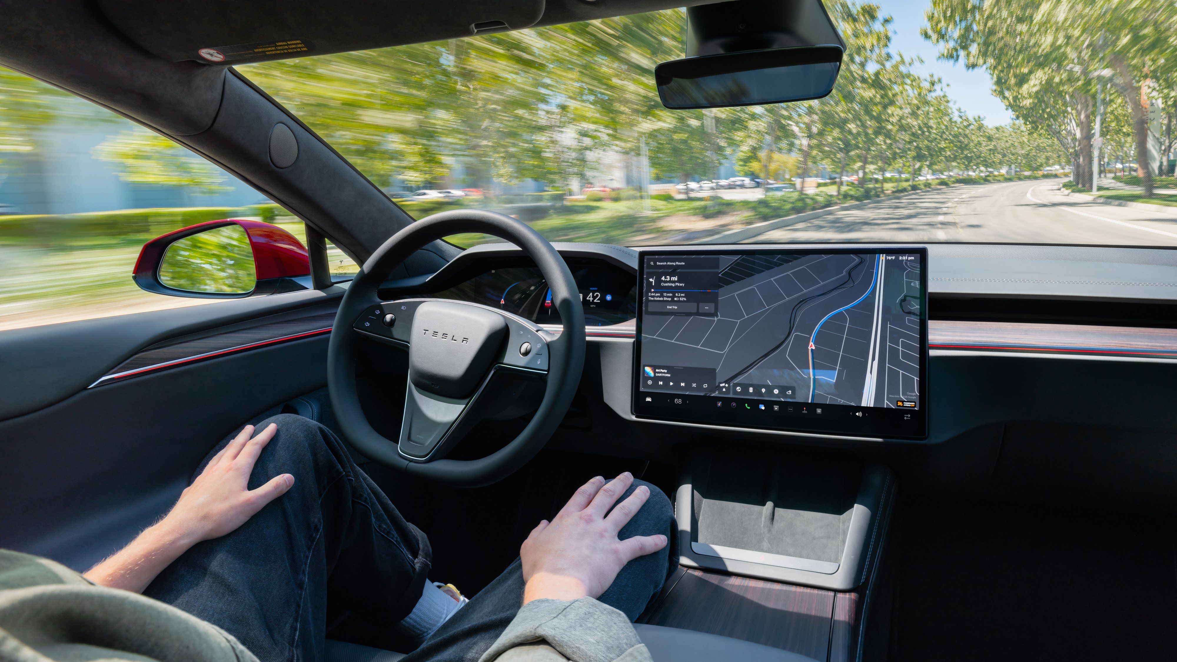 A driver using hands-free mode in a Tesla Model S. 