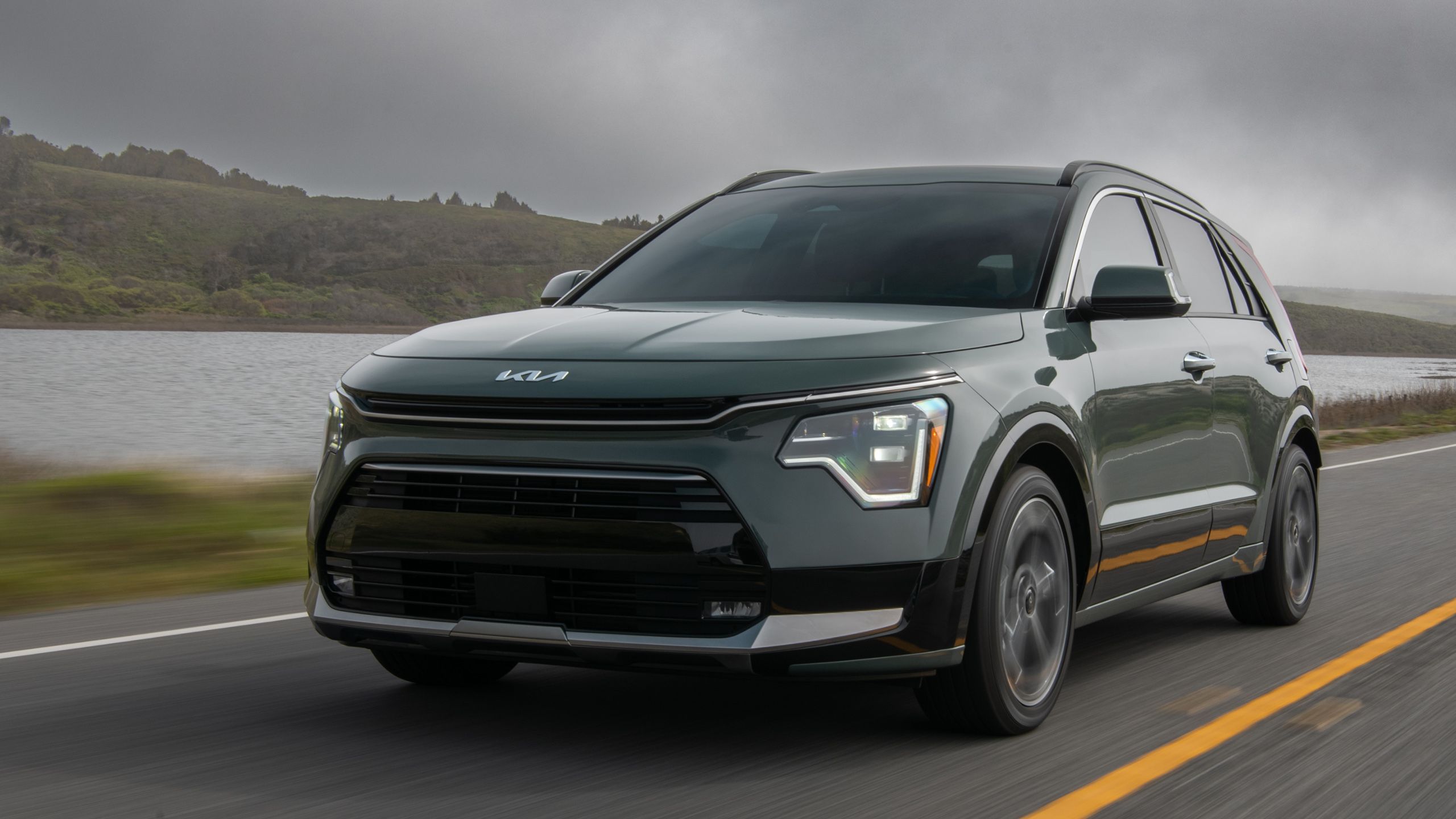 Kia Niro hybrid driving on a road. 