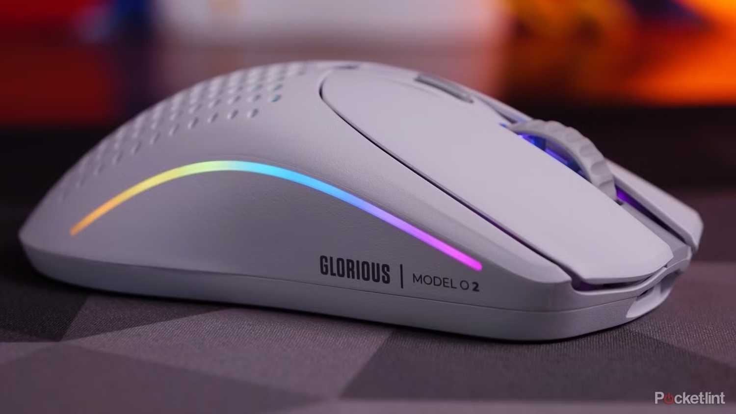 Glorious Model O2 wireless gaming mouse lit up rainbow. 