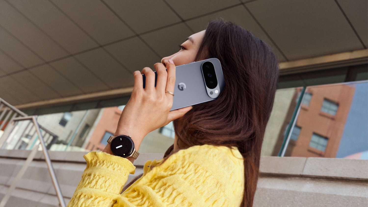A woman taking a call on a Pixel 10 Pro.