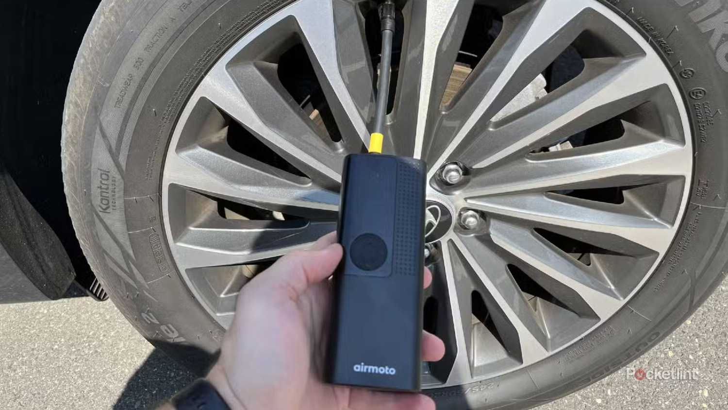 The Airmoto Smart Air Pump next to a tire.