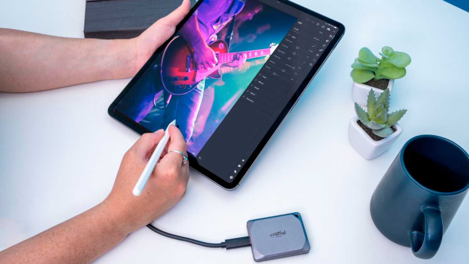 An iPad Pro paired with an Apple Pencil and a Crucial SSD.