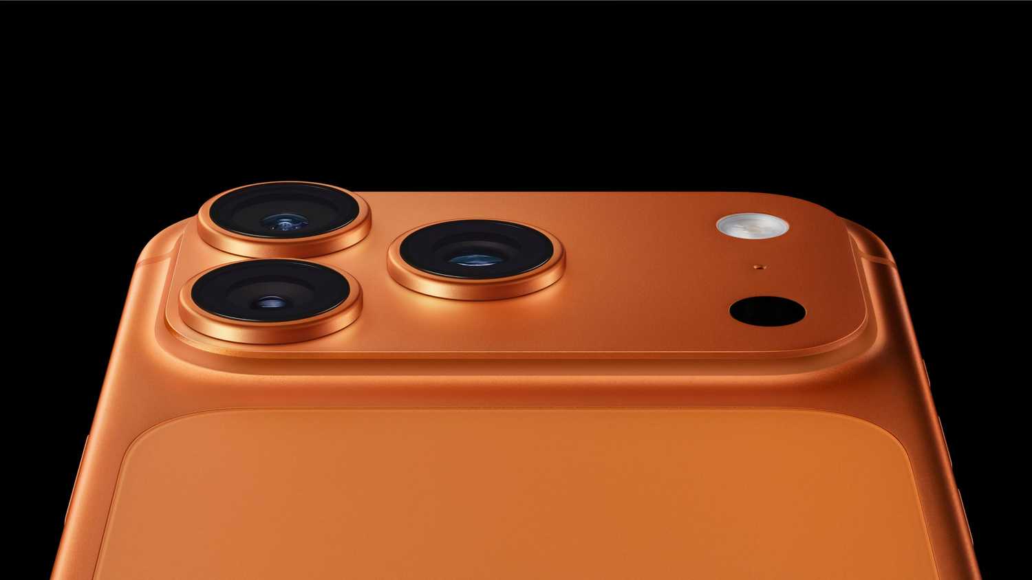 The top half of an orange iPhone 17 Pro, showing off its triple camera array.