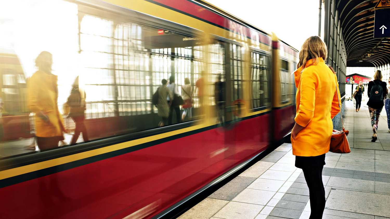 A woman standing on a train platform. 