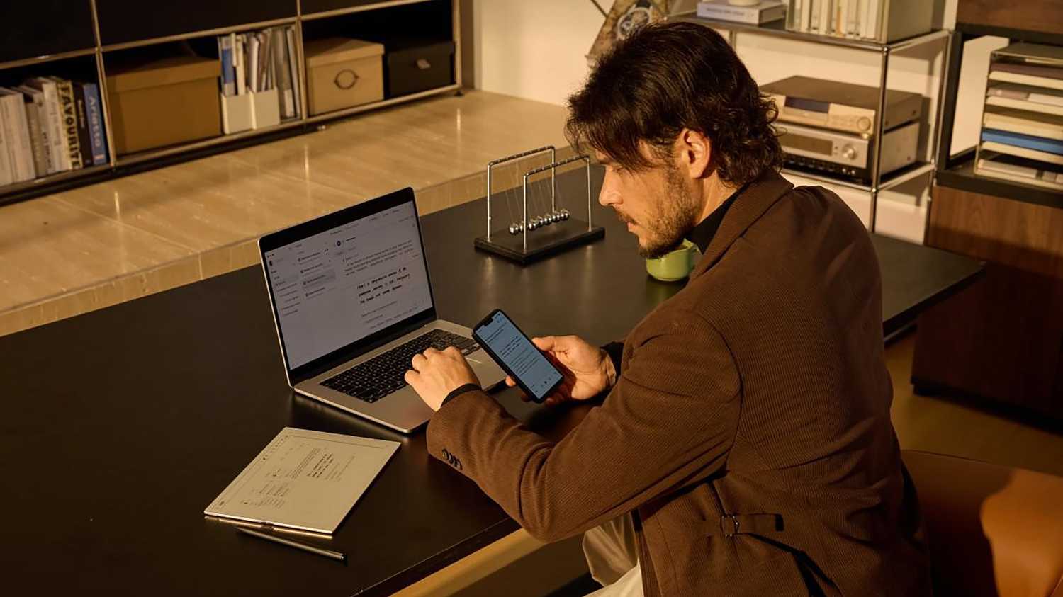 A man using the iFLYTEK AINOTE 2 while working.