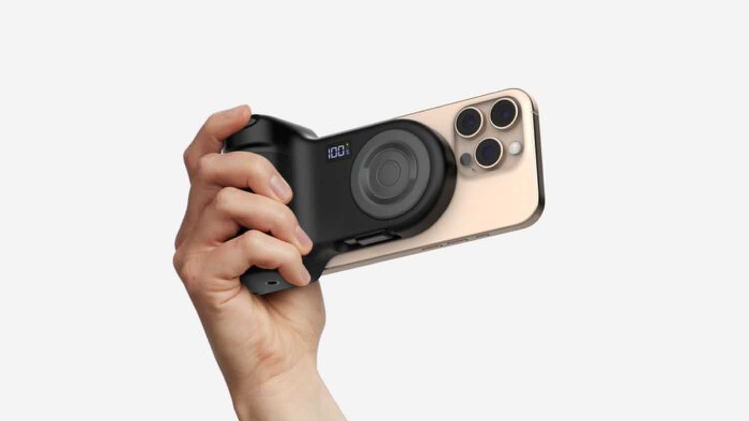 A hand holding a grip that's magnetically attached to the back of the iPhone.