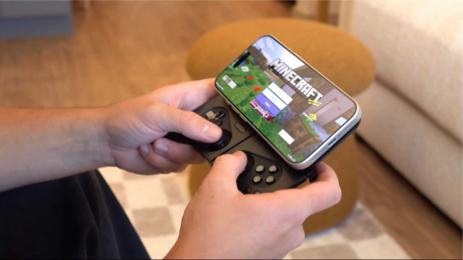An iPhone magnetically attached to a fold out controller.