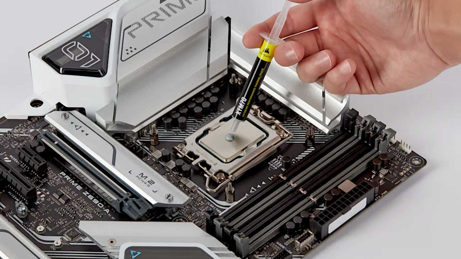 Applying thermal paste to a motherboard in prep for a new CPU.