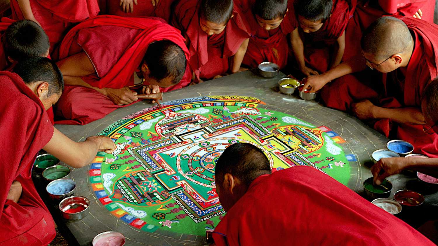 Buddhist monks crafting a sand mandala in Ron Fricke's Samsara.