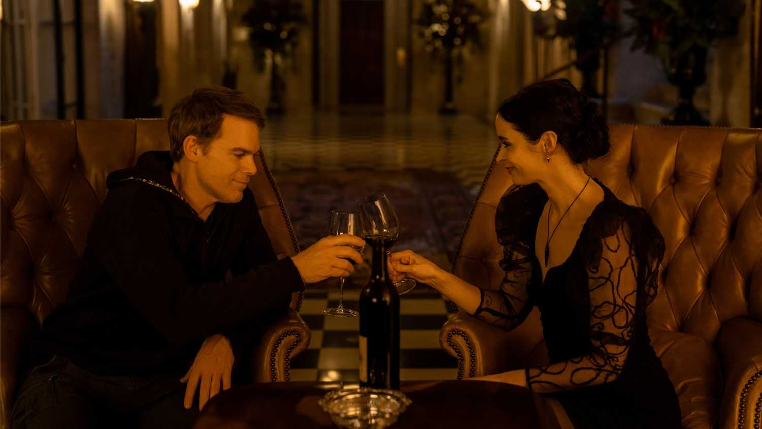 Dexter Morgan and Mia, aka Lady Vengeance, toast with wine glasses in Dexter: Resurrection season 1.