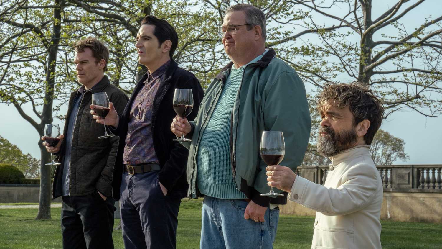 Peter Dinklage as Leon Prater with Eric Stonestreet as Al, David Dastmalchian as The Gemini Killer, and Michael C. Hall as Dexter Morgan, all holding wine glasses looking straight ahead in Dexter: Resurrection season 1.