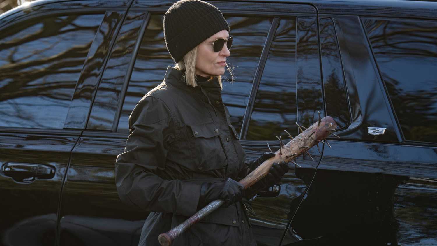 Uma Thurman as Charley, wearing all black and carrying a baseball bat full of nails in Dexter: Resurrection season 1.