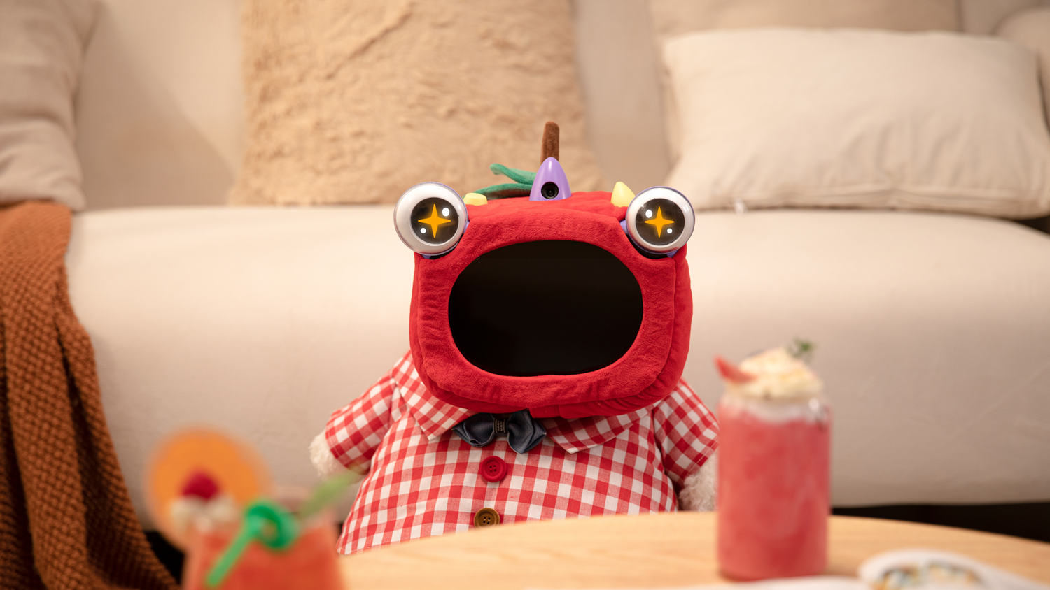 Ollobot in red in front of strawberry milkshake