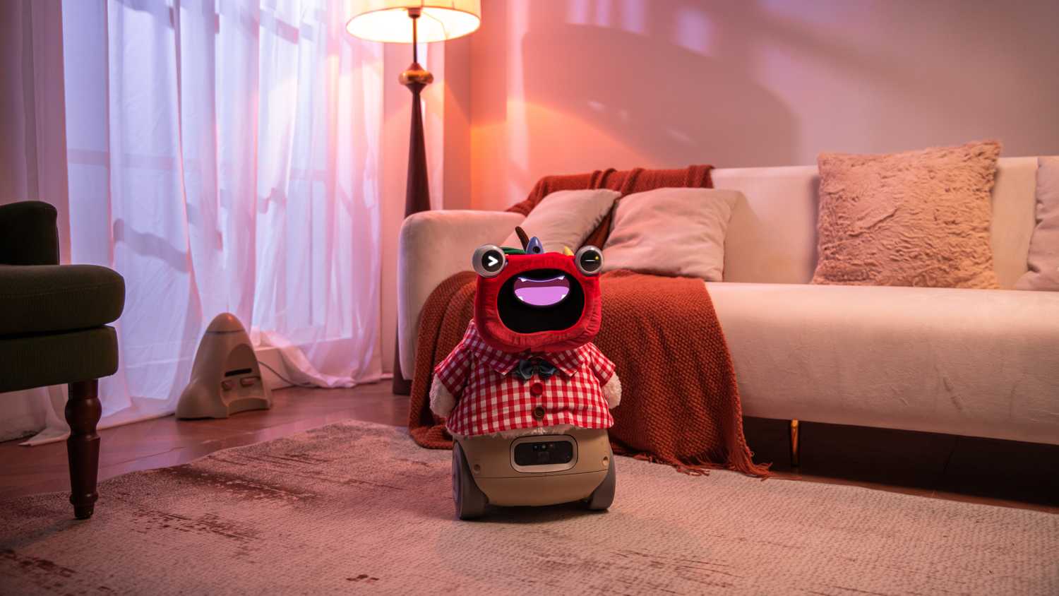 Ollobot OlloNi sitting in a living room next to a couch