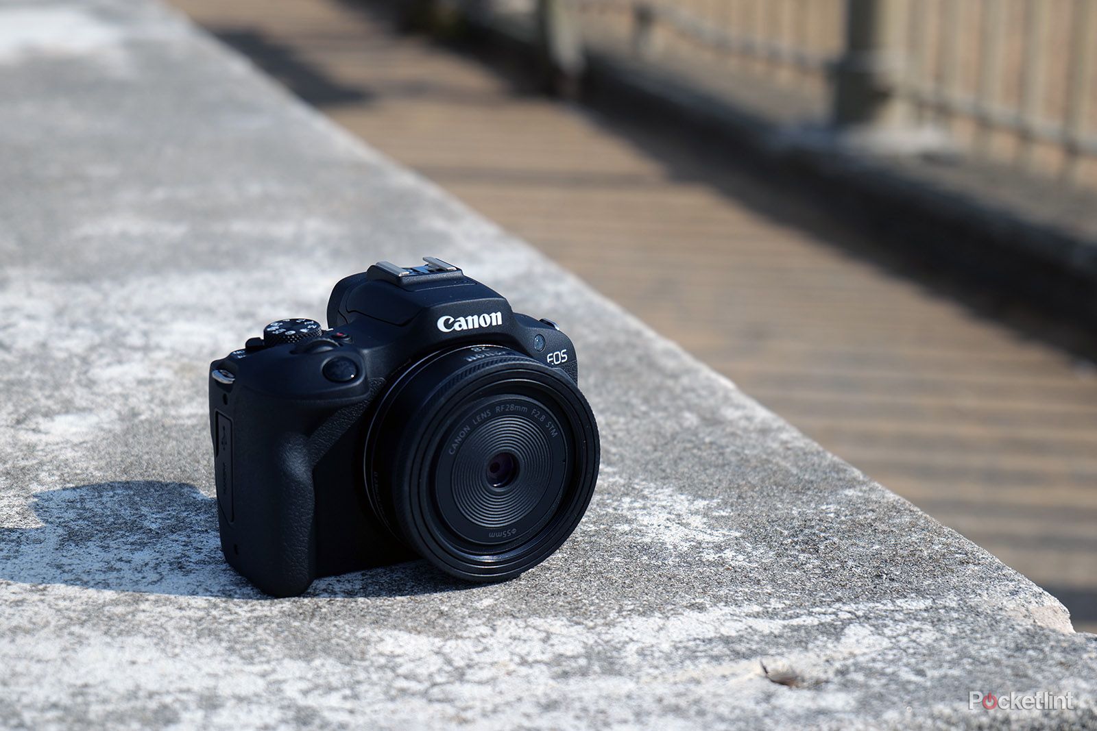 canon-eos-r100-angle-concrete.