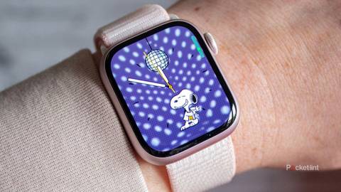 Apple Watch Series 9 with Snoopy watch face on wrist.