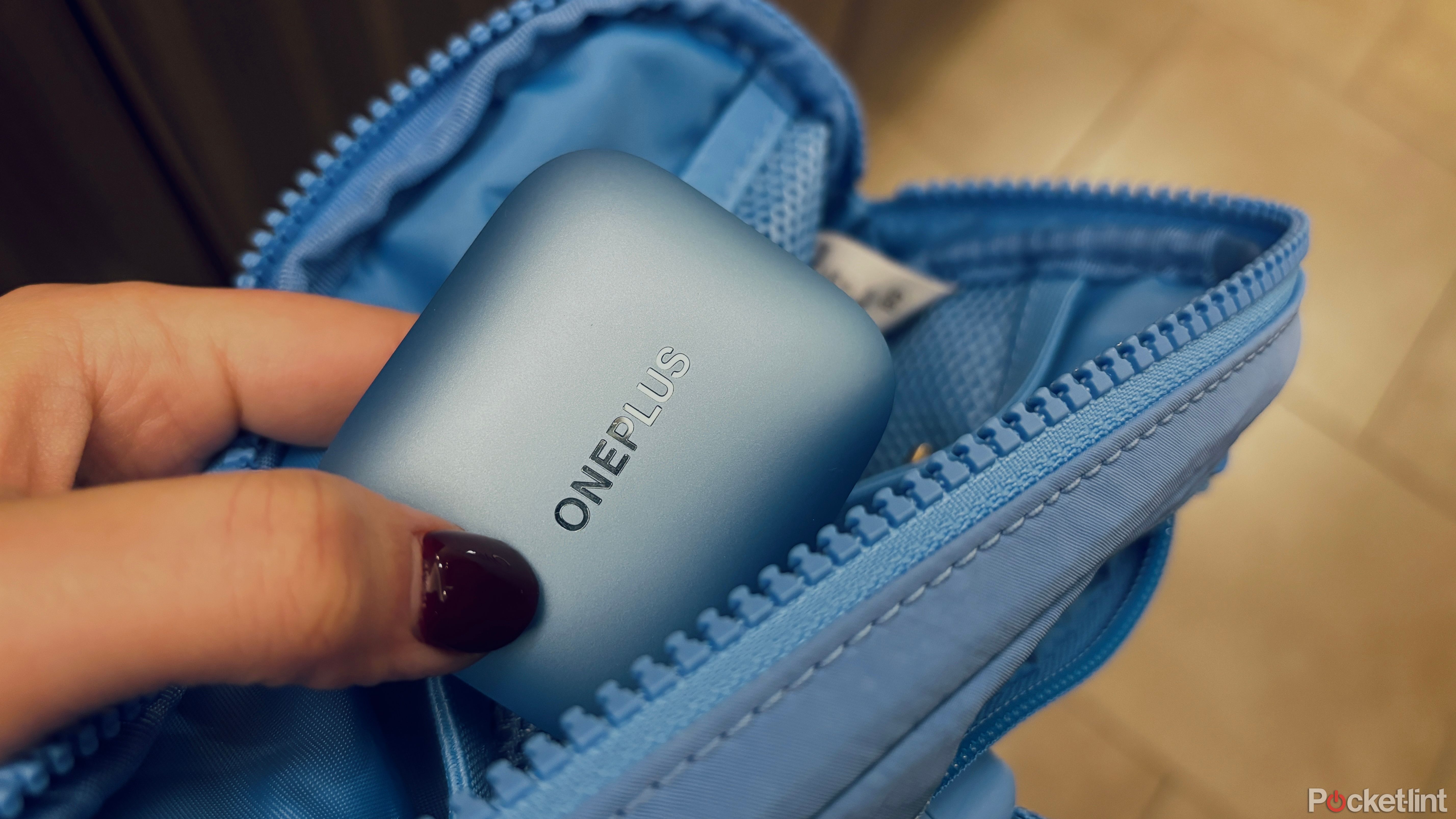 Putting OnePlus Buds 3 into blue workout bag
